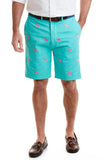 A pair of men's embroidered shorts in green with a pink elephant pattern. The shorts have a flat front design, pockets on the sides, and a button-and-zip fly closure.
